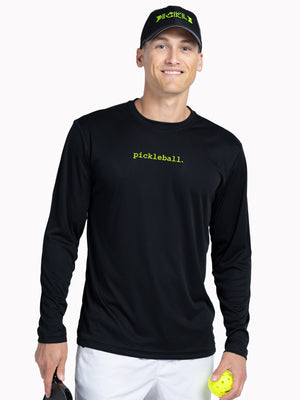 Man wearing a black long-sleeve shirt with 'pickleball' text, holding a paddle and ball, on a white background