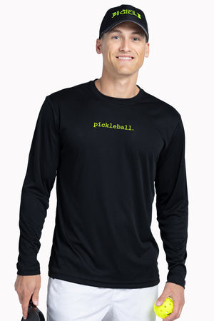 Man wearing a black long-sleeve shirt with 'pickleball' text, holding a paddle and ball, on a white background