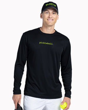 Man wearing a black long-sleeve shirt with 'pickleball' text, holding a paddle and ball, on a white background